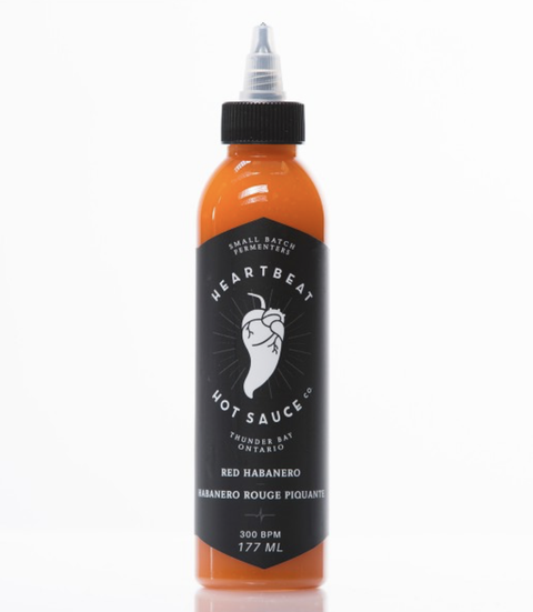 heartbeat hot sauce red habanero bottle with bold heat from fresh red habaneros, garlic, and sweet bell peppers. vegan, gluten-free, and all-natural.